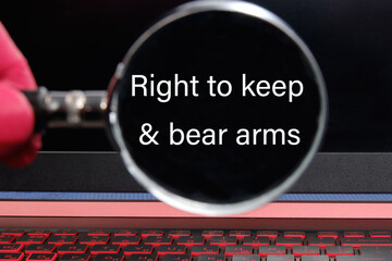 right to keep and bear arms text written through a magnifying glass on a black laptop screen