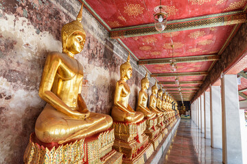 Row of gilded Buddha statues in Wat Suthat Thepwararam, Bangkok