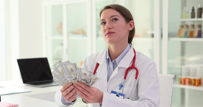 Corrupt female doctor counts money in clinic