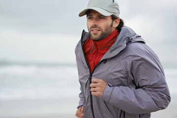 Beach, man or running for exercise, training or wellness outdoor in nature to workout for body health. Ocean, athlete or person jog for fitness, cardio or sport with energy at sea in winter on mockup