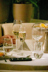 Glasses with wine in row background at restaurant party