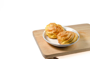 Soes Cake also known as Choux Pastry displayed on a wooden plate