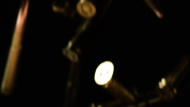 Slow Motion Of 300 AAC Blackout And 9mm Parabellum Cartridges Falling Against Black Backdrop. closeup shot