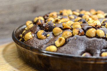 view of chocolate cake with hazelnuts, close up view of ice cream food background,