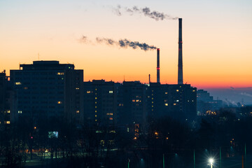 View across the Poland City of Tychy with two chimneys with a sunrise background