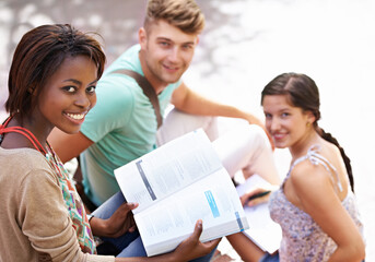 Studying, university and portrait of students with books on campus for learning, knowledge and reading. Education, friends and man and women with textbook for group work, exam preparation and college