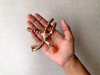 hand holding a muslim rosary or tasbih