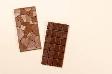 Chocolate bars on beige background