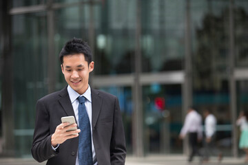 Chinese business man using his mobile phone.
