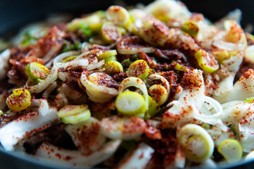 The vegetables seasoned with soy sauce in the pot before boiling