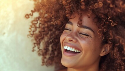 Happy laughing American African woman with her curly hair. Laughing curly woman in sweater touching her hair and looking at the camera
