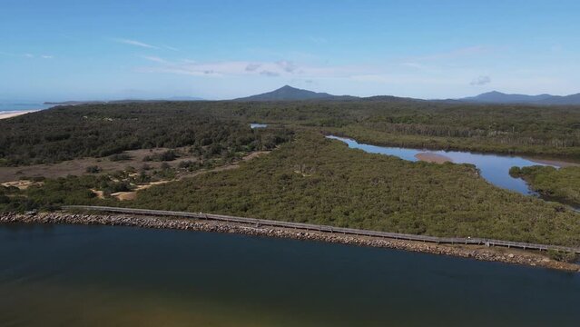 Aerial views of Urunga boardwalk along the banks of the Kalang River, to the junction with the Bellinger River and out to the ocean