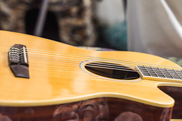Yellow acoustic guitar. Harmonic instrument. Acoustic guitar strings