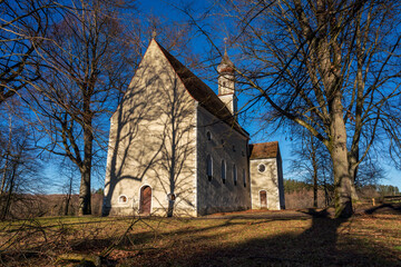 Fototapeta na wymiar Ilmmünster Church spotting through trees without leaves