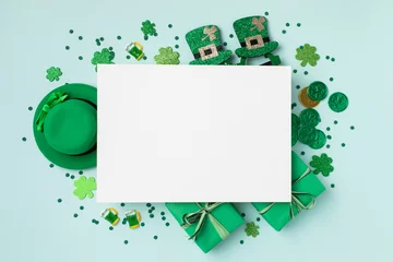 Foto op Aluminium Saint Patrick Day green background with hat, shamrock clover and accessories with gifts top view. Festive greeting card. © juliasudnitskaya