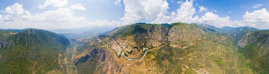 Delphi, Greece. Ruins of the ancient city of Delphi and the modern city. View of the valley. Sunny weather, Summer. Panorama 360. Aerial view