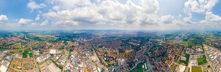 Fototapeta na wymiar Turin, Italy. Panorama of the city in summer. Industrial and residential areas. Fields. Panorama 360. Aerial view