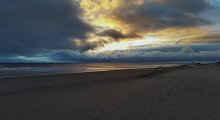 Colorful sunset on the shores of the Barents Sea. Varandey, Arctic, Russia.