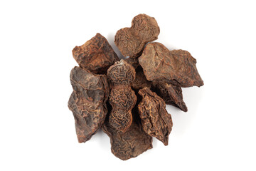 A pile of Dry Organic Shikakai (Acacia concinna) fruits, isolated on a white background. Top view