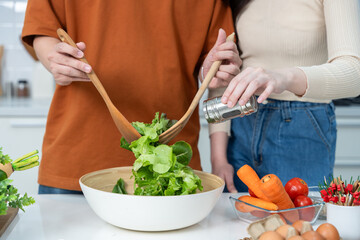 hand of loving of having fun standing vegetable salad Add ground pepper to prepare meat preparing food and enjoy cook cooking with vegetables,meat, bread while standing on a kitchen Condo life
