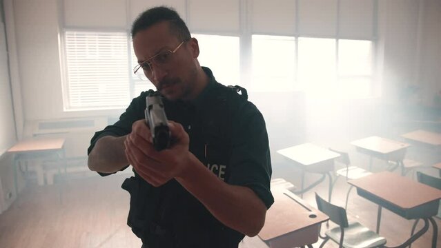 Police officer in a classroom with gun drawn