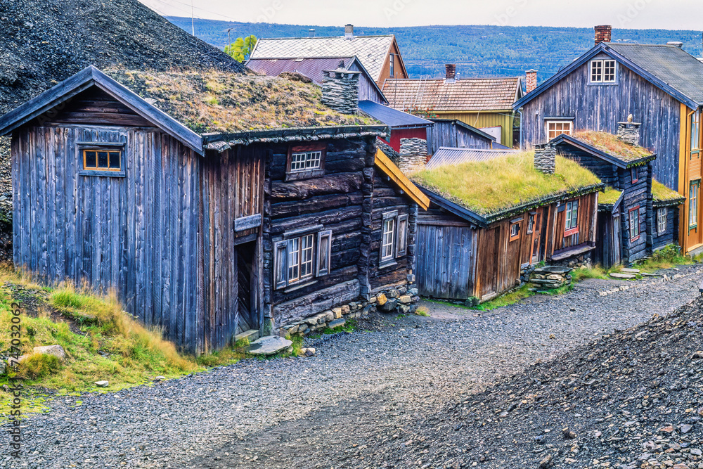 Wall mural Old wooden buildings by a street in the Røros mine village in Norway