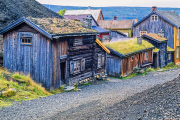 Old wooden buildings by a street in the Røros mine village in Norway
