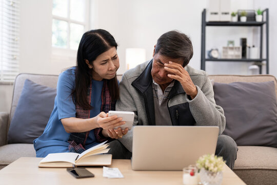 Serious stressed asian senior old couple worried about bill discuss unpaid bank debt paper payment worry about money problem