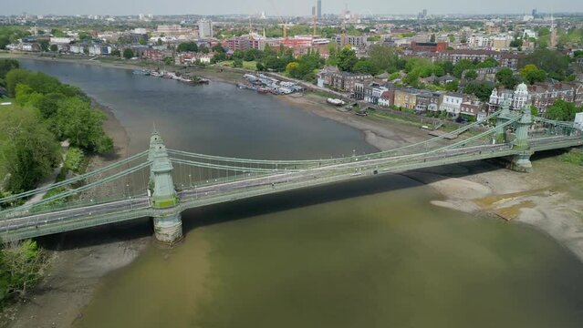 The drone aerial footage of Hammersmith bridge across River Thames in west London, links Hammersmith and Barnes.