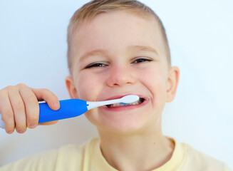 Happy child boy brushes his teeth. Healthcare, oral hygiene, people and beauty concept