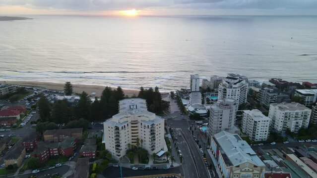 Aerial drone pullback reverse view of Cronulla in the Sutherland Shire, South Sydney, NSW Australia during an early morning sunrise in February 2024   