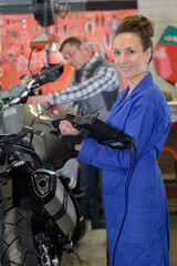 Fototapeta na wymiar female mechanic repairing motocycle engine