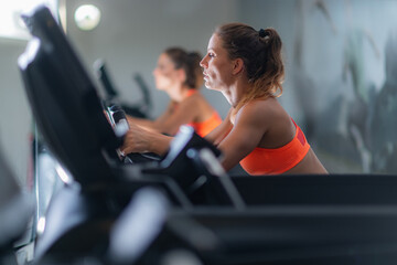 Active young woman engaging in treadmill exercise, promoting fitness and a healthy lifestyle