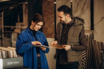 Married couple chooses ceramic tiles for kitchen or bath at a hardware store