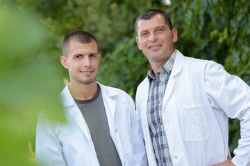 portrait of scientists checking plants outdoors