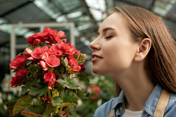 Fototapeta premium The girl is a green house worker.