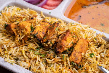 Paneer tikka biryani with onion raitha, vegetable biryani, hyderabadi biryani, south indian biryani served in plate
