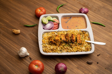 Paneer tikka biryani with onion raitha, vegetable biryani, hyderabadi biryani, south indian biryani served in plate