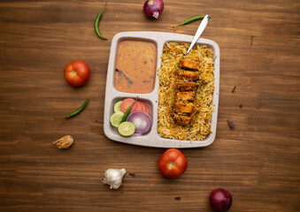 Paneer tikka biryani with onion raitha, vegetable biryani, hyderabadi biryani, south indian biryani served in plate