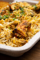 Paneer tikka biryani with onion raitha, vegetable biryani, hyderabadi biryani, south indian biryani served in plate