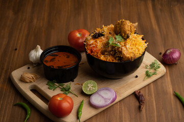 Restaurant style Spicy Chicken Biryani served with Raita and Salan, Popular Indian or Pakistani non...