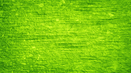 The background is a rough concrete wall overlaid with a pattern of horizontal lines dyed in a green...