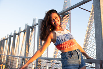 Cheerful Urban South American Woman with Long Black Hair Playing in the Rooftop During Sunset, Los...