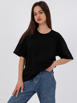 mockup of a black loose-fitting t-shirt on a young beautiful girl