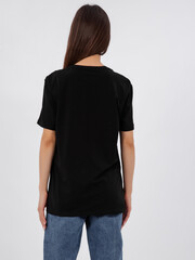 mockup of a black loose-fitting t-shirt on a young beautiful girl