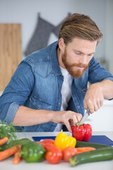 young man cutting vegetables