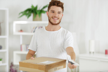 deliverer giving package box to young man