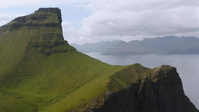 Kalsoy Island and famous Kallur lighthouse in Faroe islands. Aerial approaching shot.