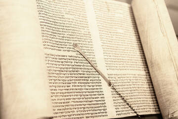 Jewish rabbi read the Torah scroll with his Torah reading hand.