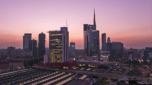Milan skyline aerial view at sunset, timelapse fromd ay to night milan italy skyscrapers top view, milano skyline in 4k.